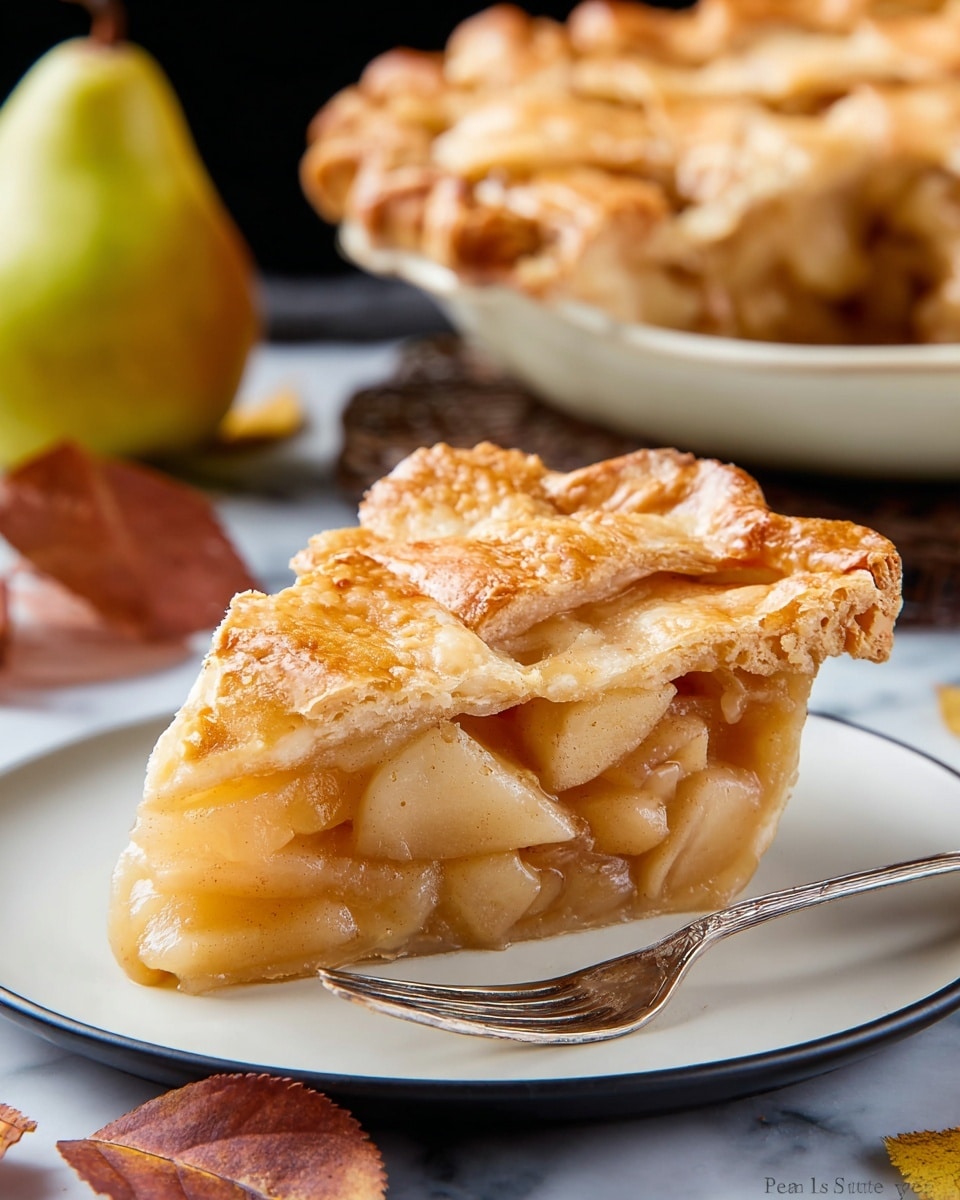 A slice of fruit pie sits on a round white plate with a silver fork next to it. The pie slice has three layers: a golden flaky crust on top with a slightly uneven texture, a thick middle layer full of soft, cooked pear pieces in light brown syrup, and a thin, firm bottom crust. The background has a whole pie with the same golden crust on a white plate, a ripe pear, and some brownish-red leaves, all arranged on a white marbled surface. Photo taken with an iphone --ar 4:5 --v 7