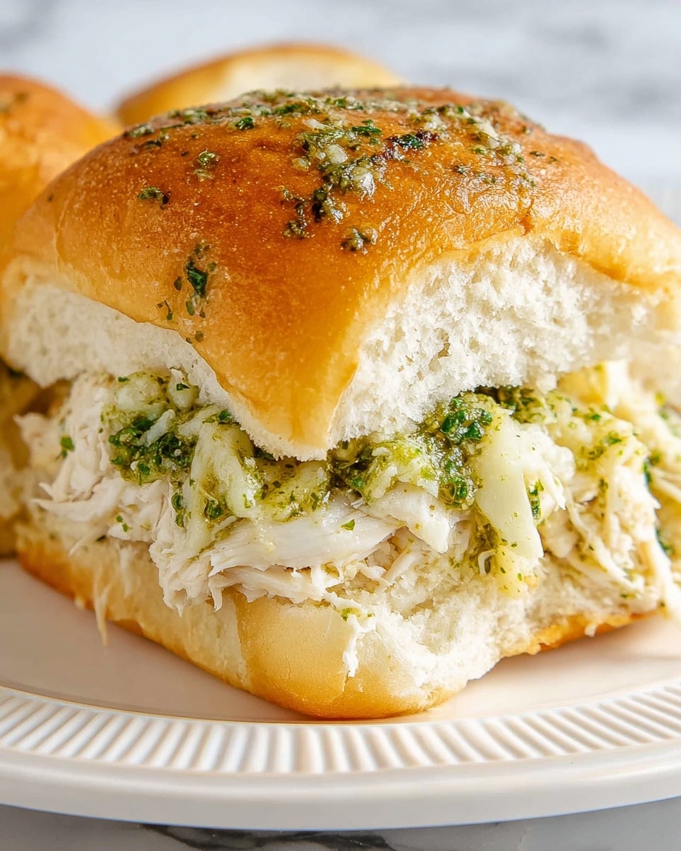 A close-up image of a rustic dark bowl filled with creamy white chickpea salad mixed with herbs, showing soft beige chickpeas coated in a thick yogurt sauce. The salad is topped with scattered fresh, bright green dill sprigs and a drizzle of golden olive oil that glistens on the surface. Dark flecks of cracked black pepper add contrast. A silver spoon rests in the bowl, partially submerged in the creamy mixture. The background is a white marbled texture, softly blurred to keep attention on the bowl. photo taken with an iphone --ar 4:5 --v 7