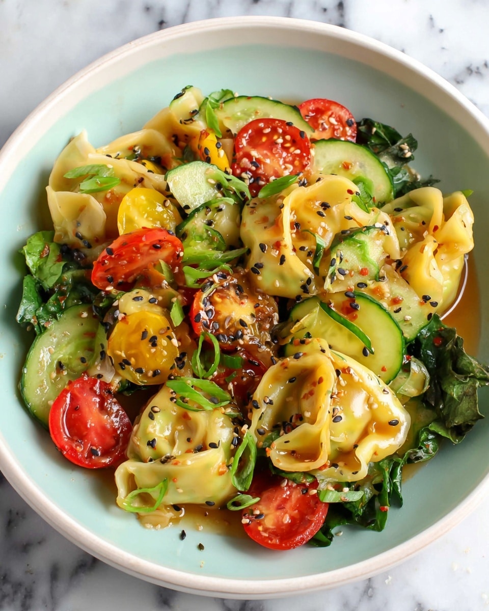 The image shows a white bowl filled with a colorful dish of folded yellow dumplings mixed with slices of green cucumber, halved red and yellow cherry tomatoes, and fresh green leafy herbs. The dumplings are glossy with a light brown sauce coating, sprinkled with small black sesame seeds, and finely chopped green onions scattered throughout. The bowl sits on a white marbled surface with a few small scattered black sesame seeds around it. The dish looks fresh and vibrant with a mix of smooth, shiny, and slightly textured elements, giving it a lively and appetizing appearance. Photo taken with an iphone --ar 4:5 --v 7