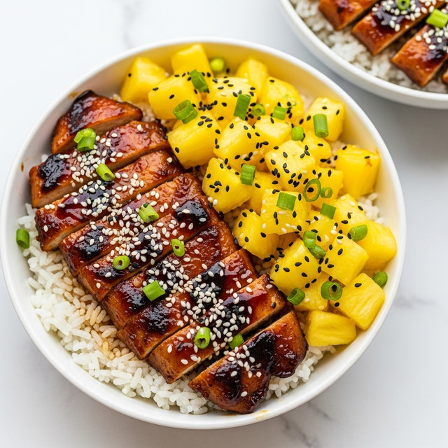 A white bowl filled with three layers: at the bottom, fluffy white rice spread evenly; on one side, golden yellow pineapple chunks with small green herb pieces sprinkled on top; and on the other side, grilled chicken pieces glazed with a dark brown sauce, sprinkled with white sesame seeds and green onion slices. Another similar bowl is slightly blurred in the background, all set against a white marbled texture. photo taken with an iphone --ar 4:5 --v 7