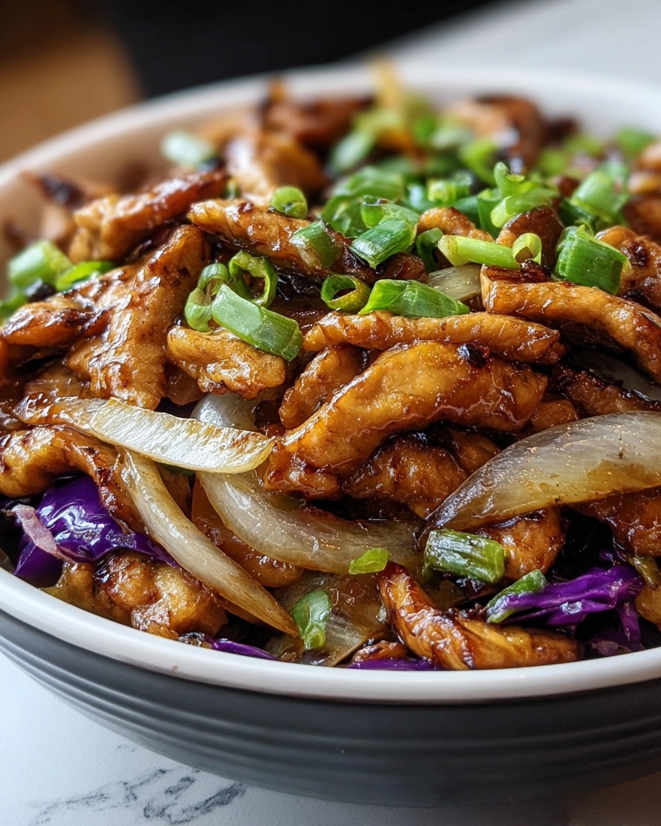 A close-up view of a bowl filled with stir-fried chicken strips as the main layer, golden-brown and glossy with a slight char on the edges, mixed with translucent white onion slices and small pieces of green onion scattered on top. There are also thin strips of purple cabbage adding a splash of color among the layers. The bowl is white, and the dish is set on a white marbled surface. The image captures the texture and shine of the cooked ingredients with a soft focus background. Photo taken with an iphone --ar 4:5 --v 7