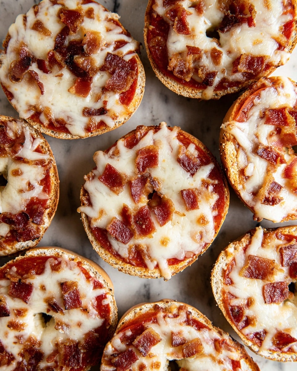 The image shows seven mini pizzas made on bagel halves, arranged closely on a white marbled surface. Each bagel has three visible layers: the bottom toasted beige bagel, a layer of red tomato sauce on top, and a thick layer of melted, slightly browned white cheese covering the surface. On top of the cheese, there are scattered pieces of pepperoni and bits of crispy reddish-brown bacon, giving the pizzas a rich, textured look. The bagels are placed in a loose cluster, showing some of the edges and the hole in the center of each bagel. Photo taken with an iphone --ar 4:5 --v 7