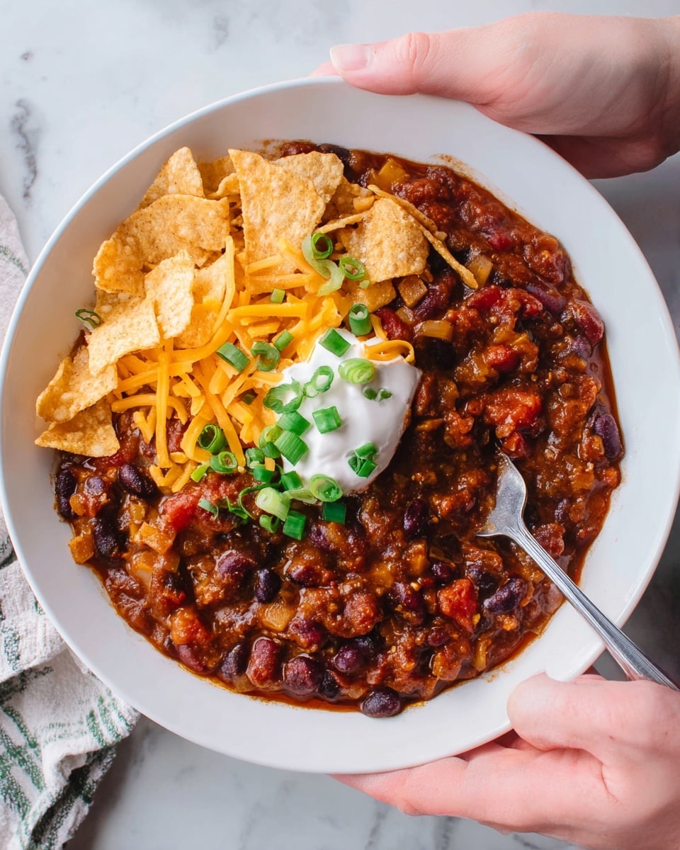 A square piece of baked layered dish is placed on a white plate with a silver fork beside it. The bottom layer is golden yellow and crumbly, topped by a creamy white and green spinach mixture in the middle. The top layer is a slightly crispy, golden yellow crust with melted cheese and bits of herbs sprinkled on top. In the background, part of a white bowl and a red baking dish are visible with fresh green spinach leaves placed next to the plate, all set on a white marbled surface. photo taken with an iphone --ar 4:5 --v 7