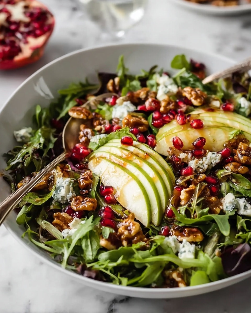 A fresh salad is served in a white bowl placed on a white marbled surface. The bottom layer consists of mixed green leafy vegetables including arugula and other greens with varied green shades and soft textures. On top of the greens are scattered bright red pomegranate seeds adding a jewel-like sparkle. There are thin slices of light green to pale yellow avocado and pear pieces arranged throughout, contributing smooth and juicy textures. A generous sprinkle of small chunks of light blue cheese with crumbly texture is spread evenly. The salad is finished with a layer of glossy brown walnuts that look roasted and slightly shiny, giving crunch and warmth. A silver fork rests inside the bowl as if ready to mix the ingredients. The photo taken with an iphone --ar 4:5 --v 7