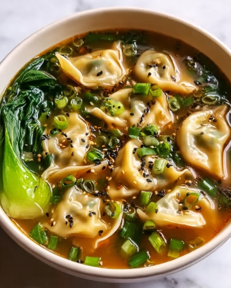 A white bowl filled with a vibrant salad made of three main layers: bright orange thin carrot sticks, light green cucumber slices, and green edamame beans, all mixed evenly. The salad is sprinkled with small white sesame seeds and tiny red chili flakes, adding texture and color contrast. The bowl sits on a white marbled surface, with a striped cloth in soft cream and blue colors partially visible in the background, next to a stacked set of white teacups with gold rims. photo taken with an iphone --ar 4:5 --v 7