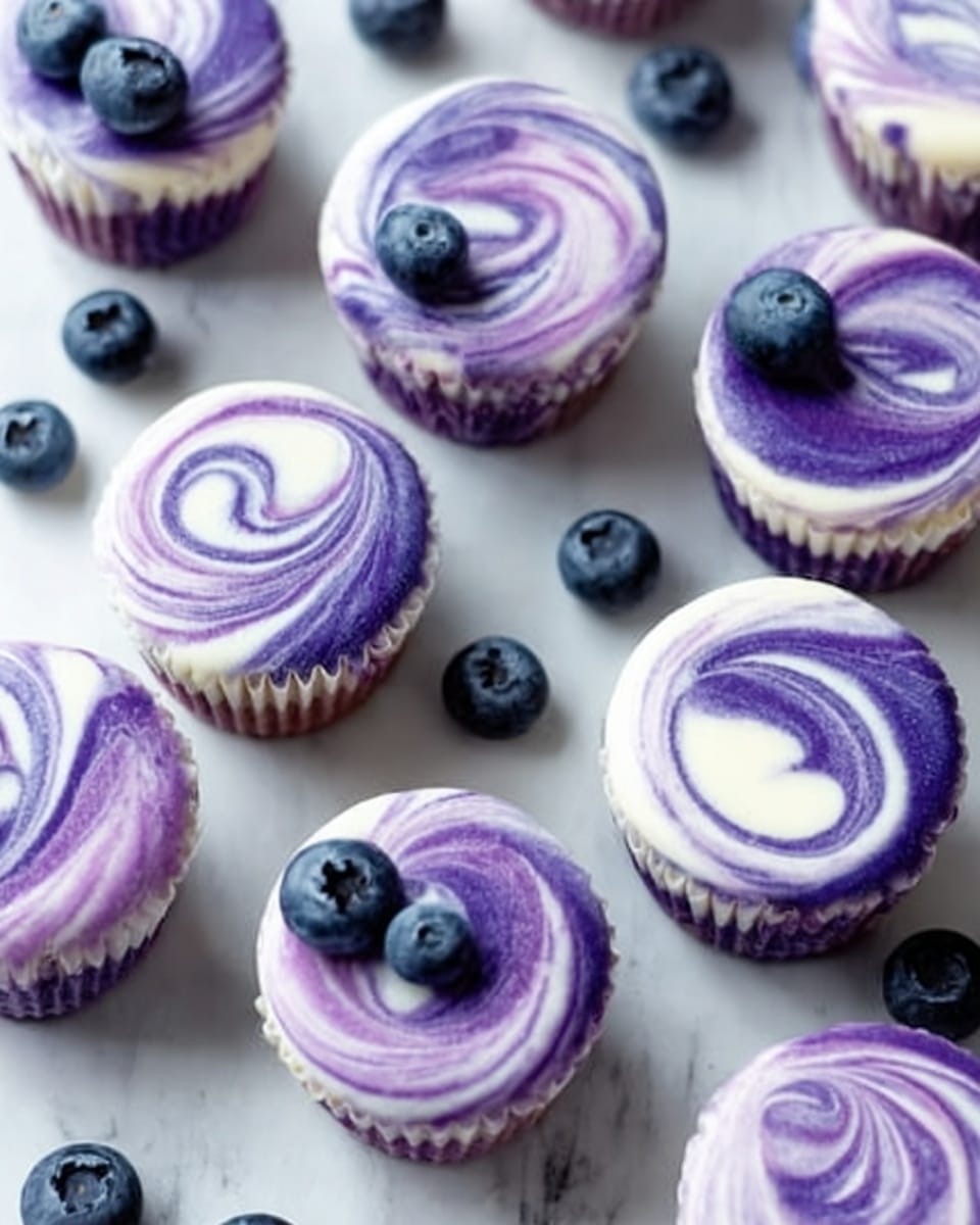 A white bowl filled with a colorful salad shows several layers of ingredients. The bottom layer has light beige chickpeas, covered irregularly by bright green avocado chunks with a slightly soft texture. Scattered over the avocado are small white cubes of feta cheese that have a crumbly texture. Thin slices of purple-red onion curve gently across the top. The whole salad is sprinkled with finely chopped green herbs and black pepper. The bowl sits on a white marbled surface. Photo taken with an iphone --ar 4:5 --v 7